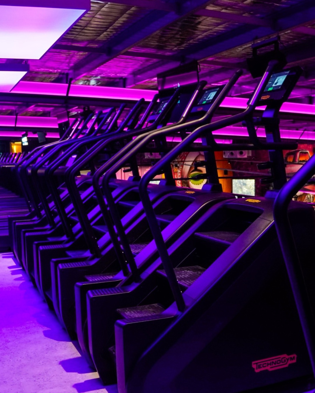 Illustrative image of a gym cardio zone with stair climbers.